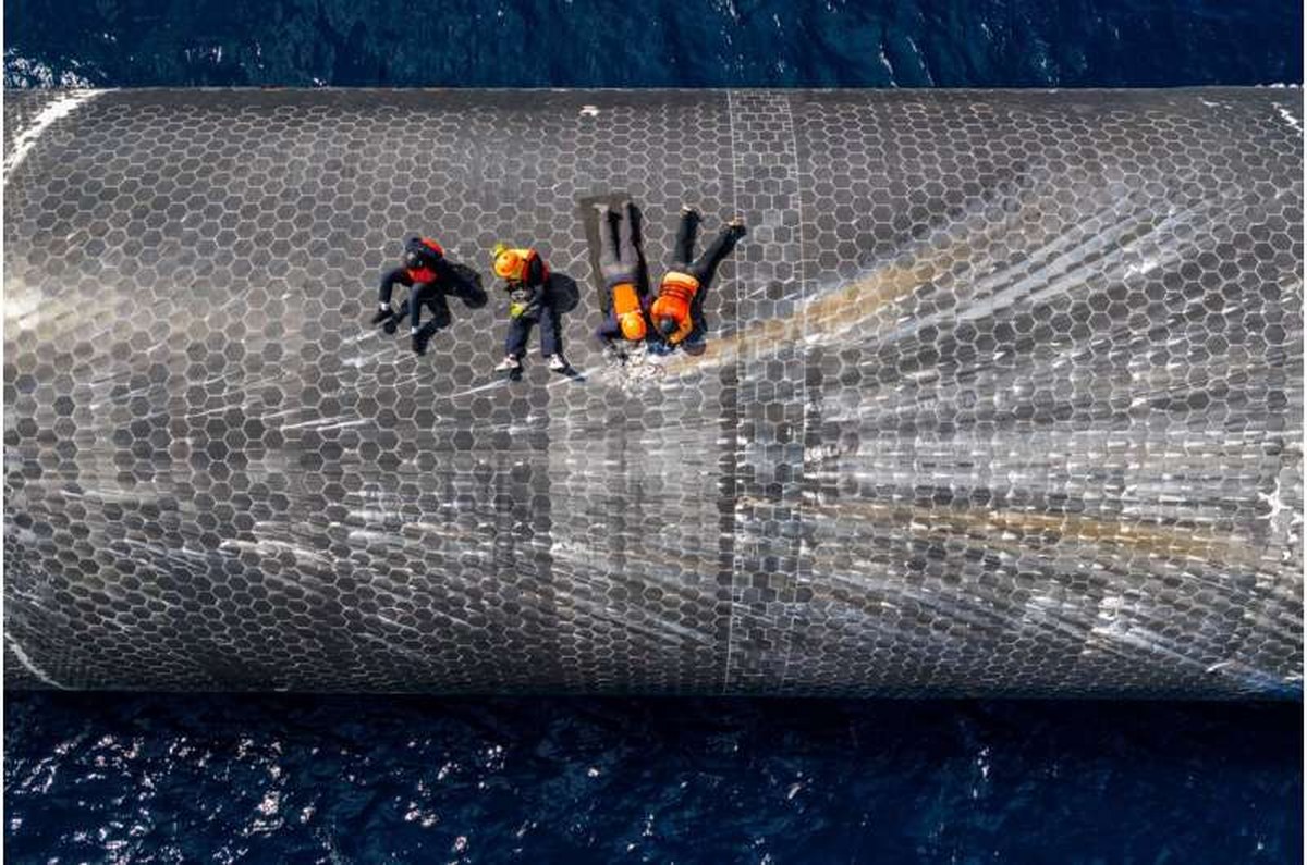 This image provided by SpaceX on Aug. 27, 2026, shows engineers inspecting Starship off the coast of Christmas Island in the Indian Ocean, following its launch on a test flight back in July. Credit: SpaceX via AP SpaceX recovers Starship from the Indian Ocean a month after launch and is shipping it back to Texas