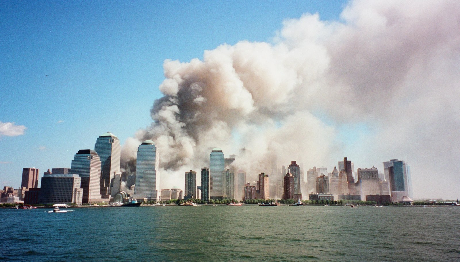a cloud of smoke billows above lower manhattan