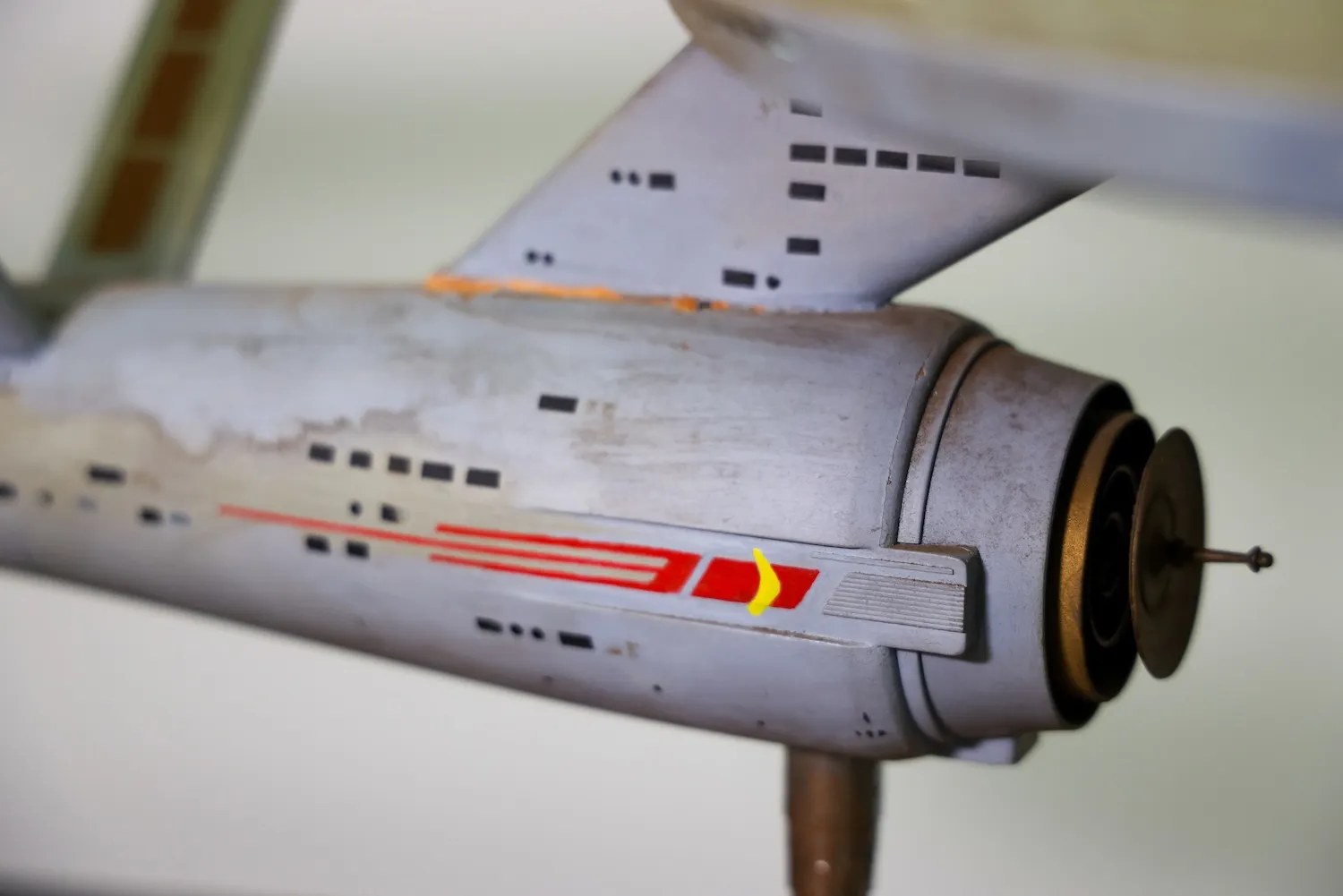 Close up of USS Enterprise model base showing wear and tear