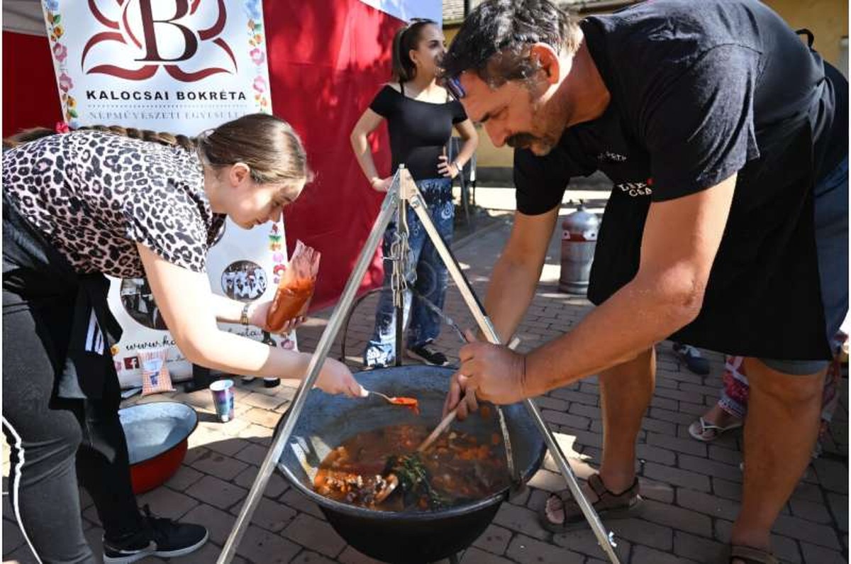 Teams competing in a cooking contests poured generous amounts of paprika into their cauldrons. Teams competing in a cooking contests poured generous amounts of paprika into their cauldrons