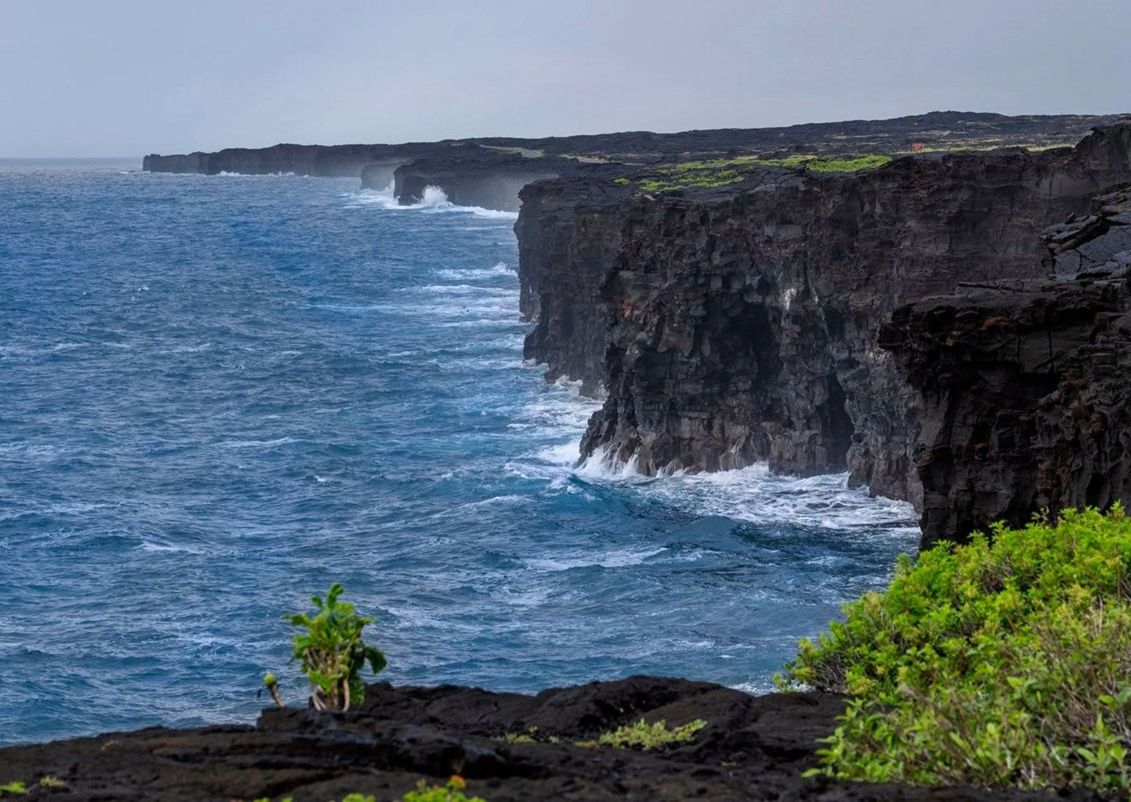 a cliff made of volcanic rock over the ocean