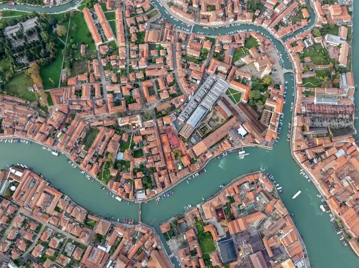 Aerial image of picturesque canals and colourful rooftops in Murano, a historic old town in Venice.