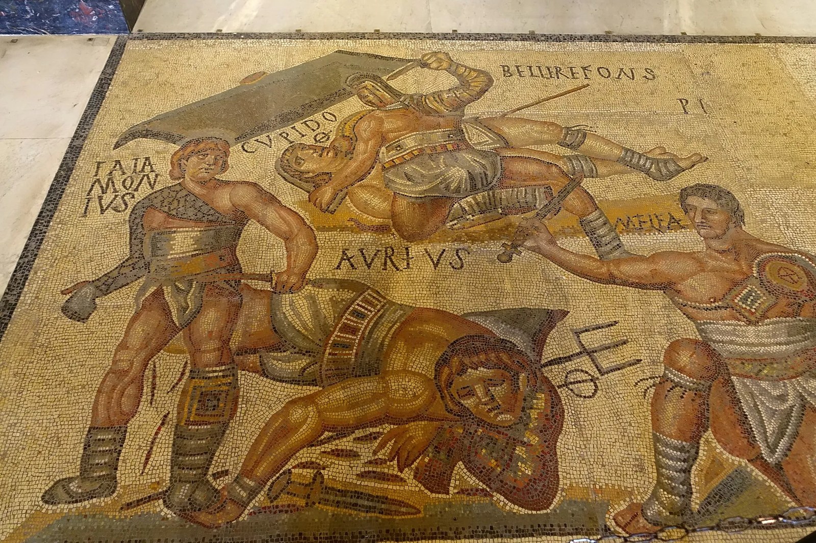 Mosaic shows different kinds of gladiators fighting.