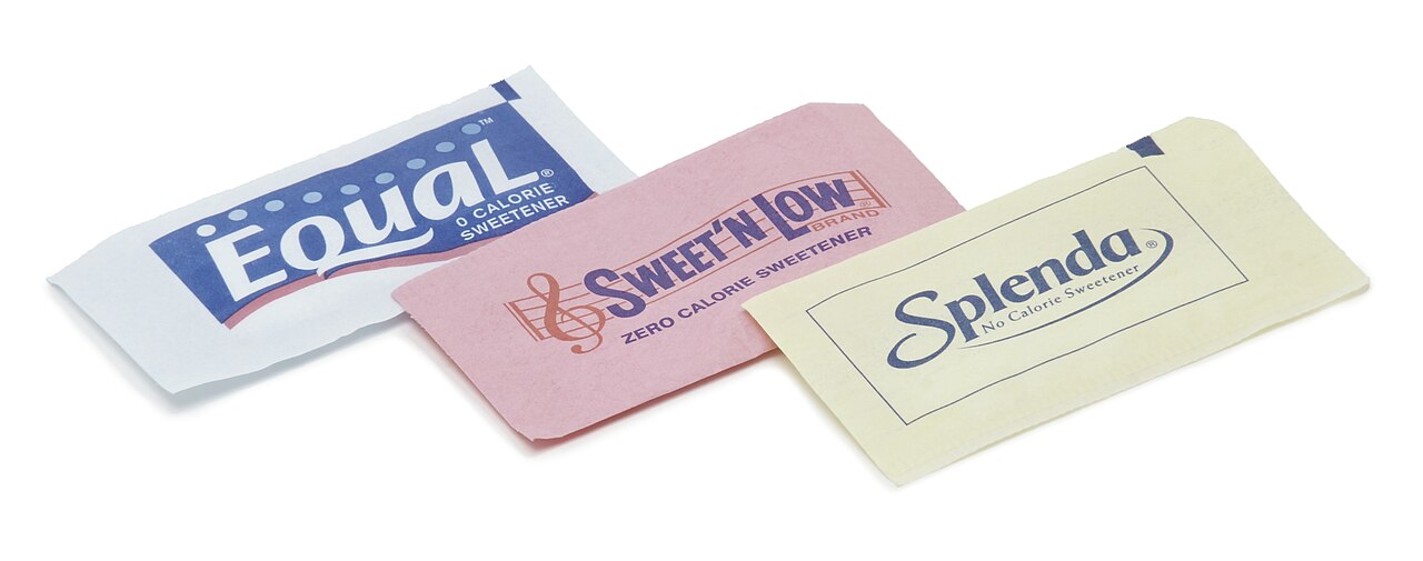 Three artificial sweeteners in paper packets, coded by color: Equal (aspartame; blue), Sweet'N Low (saccharin, pink)[note 1] and Splenda (sucralose, yellow). Other colors used are green for stevia.[1]